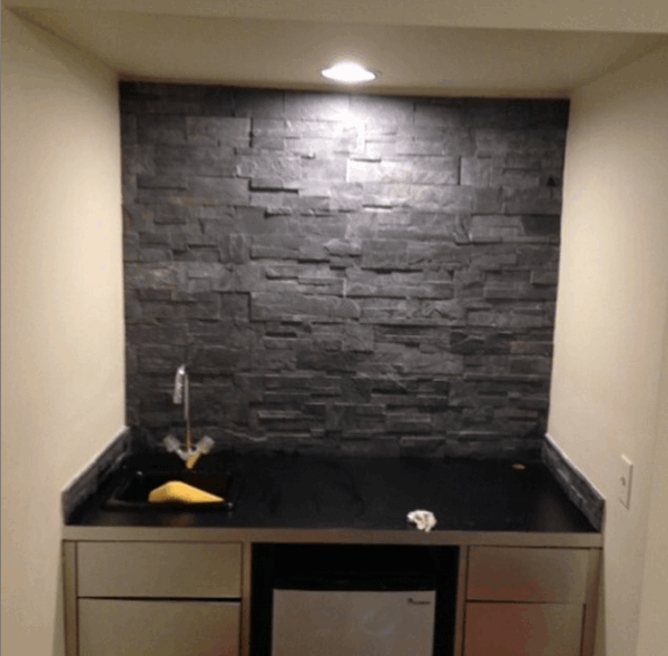 Stainless steel cabinet with black stone wall